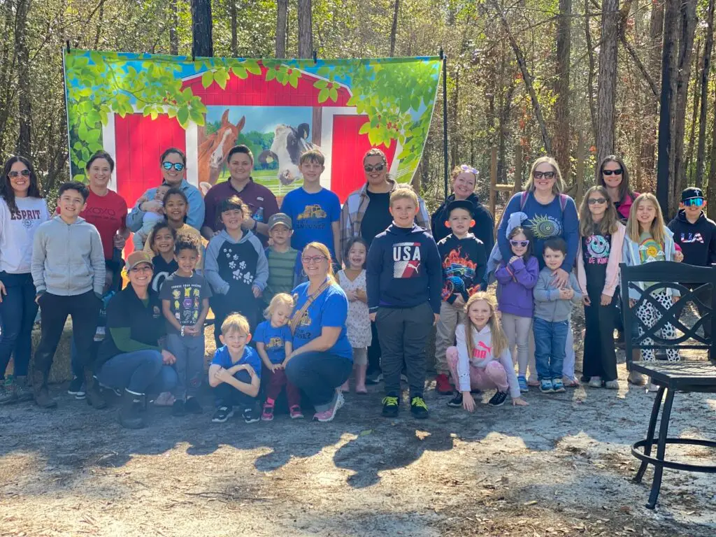 Families and children gathered at Healing Hooves Farm in Middleburg during a homeschool farm tour.