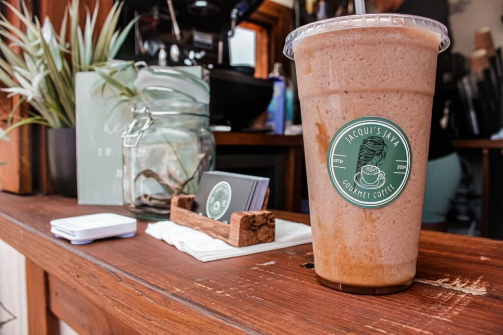 A blended coffee in a branded Jacqui's Java cup on the wooden trailer counter