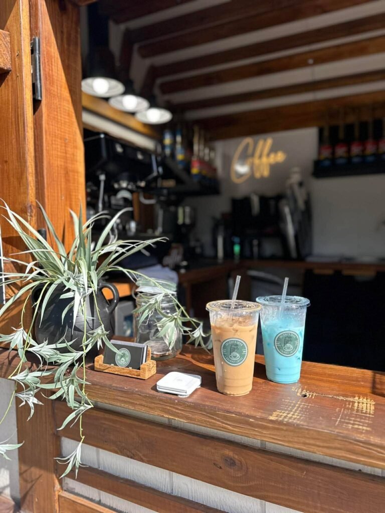 An iced coffee and a blue raspberry spritzer on the counter of the Jacqui's Java coffee trailer
