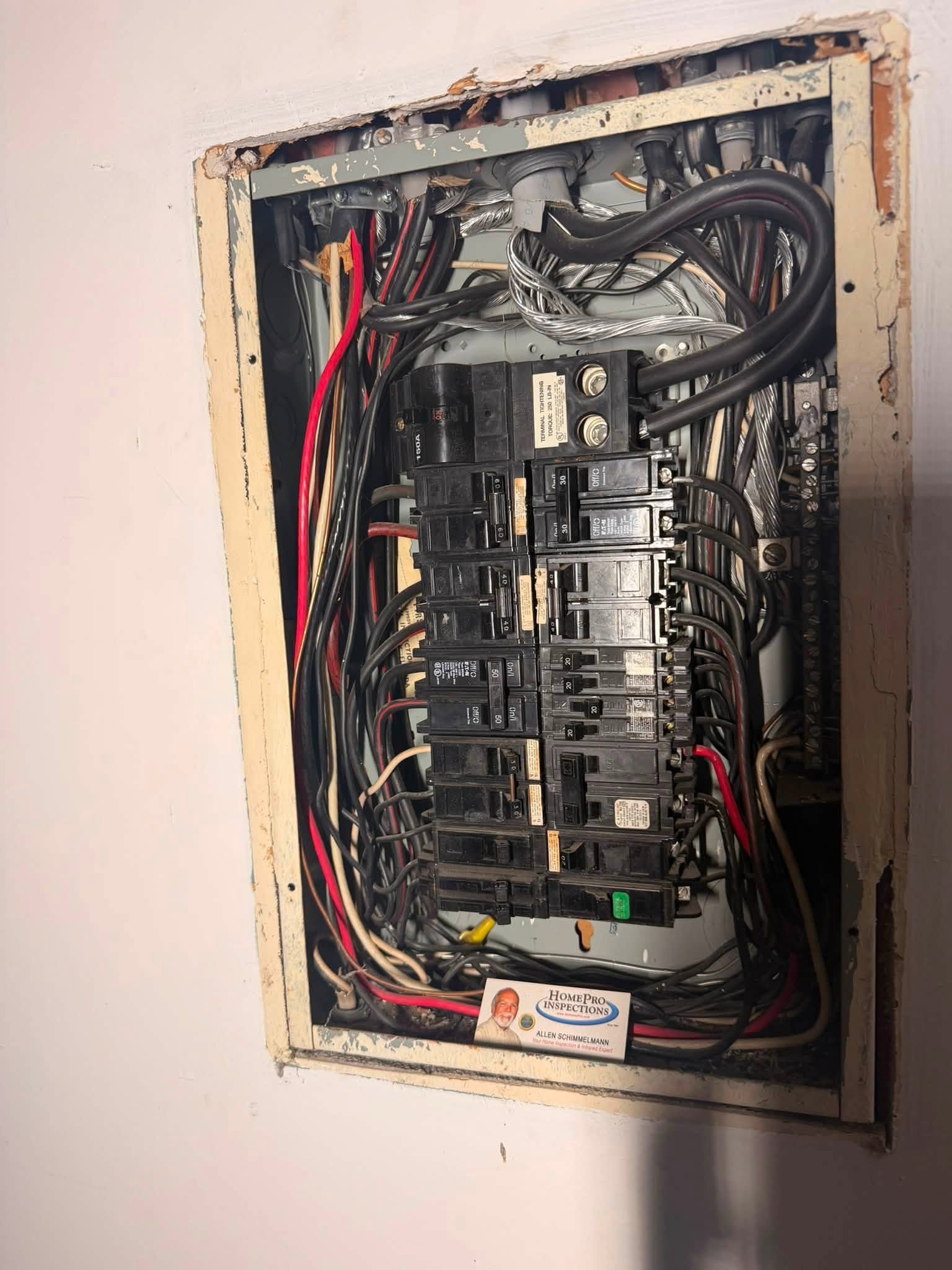 Old, disorganized electrical panel before replacement