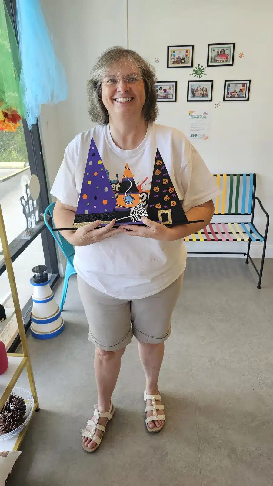 Let's Create Studios owner showing Halloween witch hat crafts in the Middleburg studio