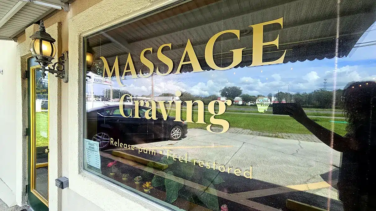 Gold Massage Craving lettering on the front window with the tagline Release pain, feel restored