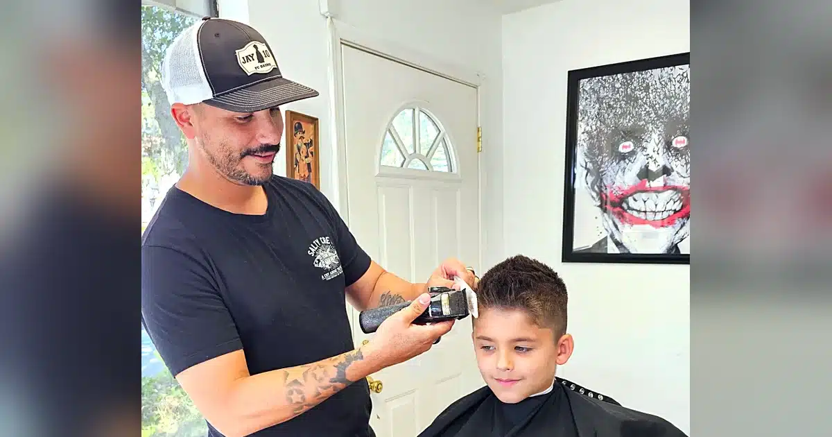 Jay the barber cutting a young client's hair at Intermissions Barbershop in Green Cove Springs