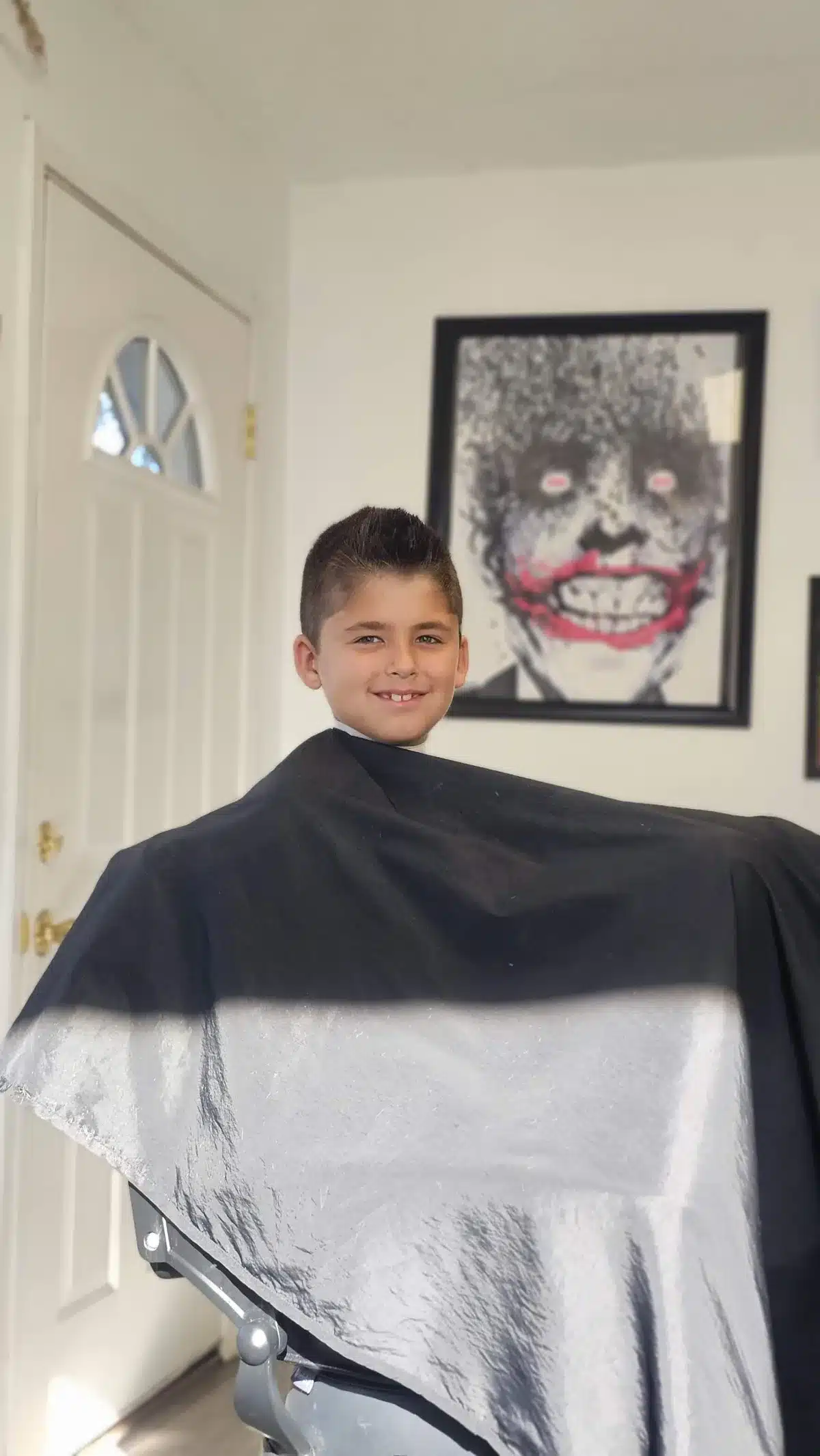 Smiling boy showing off a finished haircut at Intermissions Barbershop in Green Cove Springs
